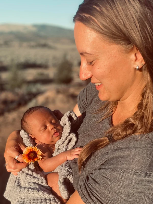 Proud mom cuddling her baby at the City of Refuge group home