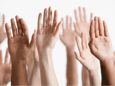 Hands raised to volunteer